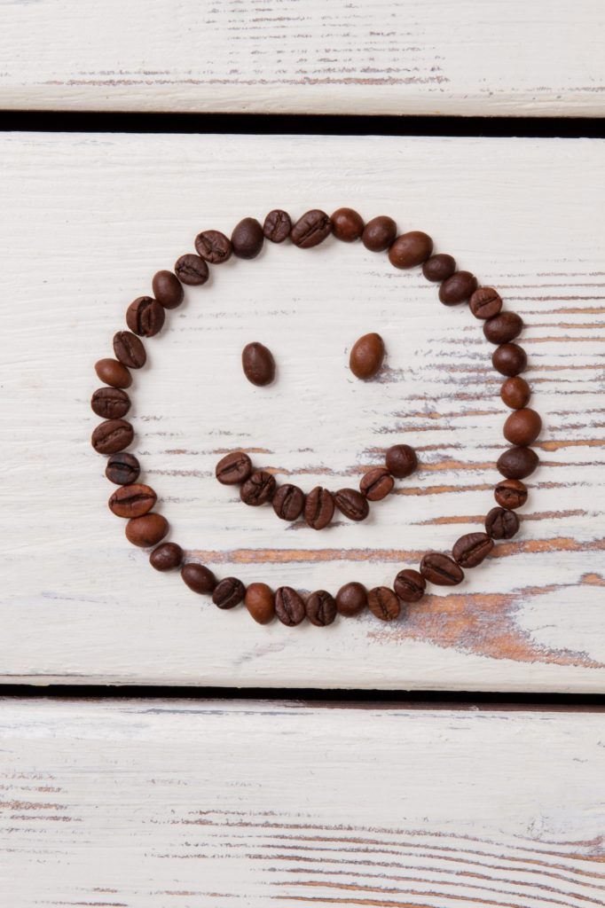 Simple happy smiling face made of coffee beans.