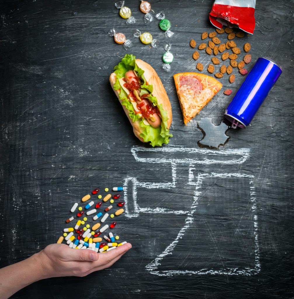 fast food and medicines on a black background